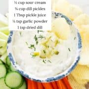 Dill pickle dip in a bowl with ingredients listed.