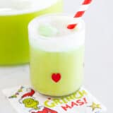 Grinch punch in a glass cup.