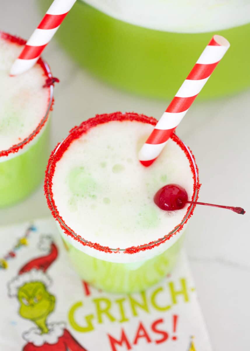 Grinch punch in a glass cup.