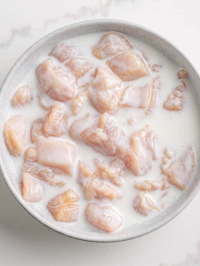 Soaking boneless chicken wings in buttermilk.