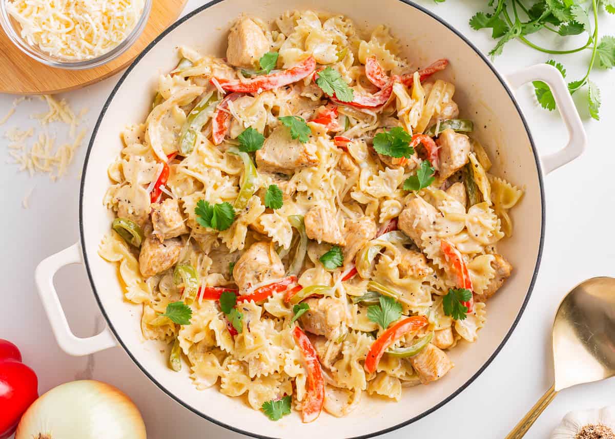 Chicken fajita pasta in a white skillet.