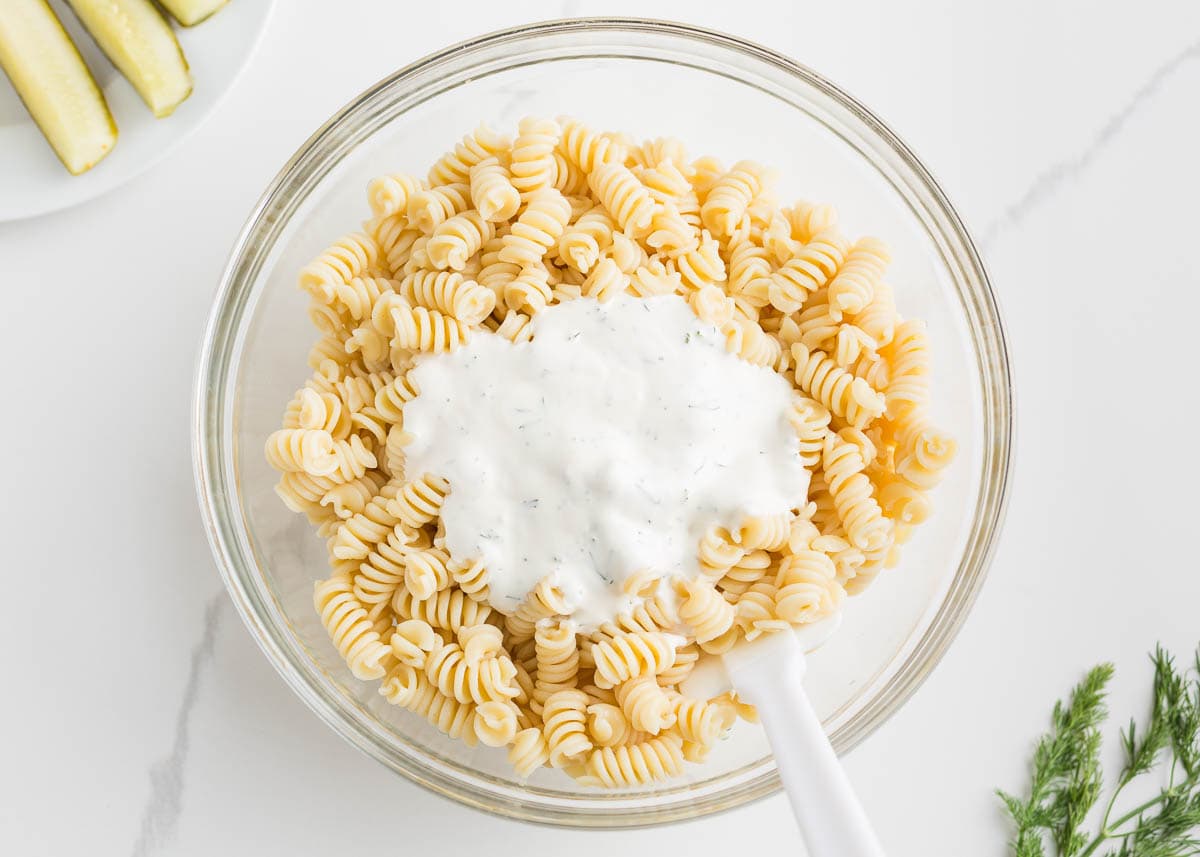 Pasta in a bowl with pasta salad dressing.