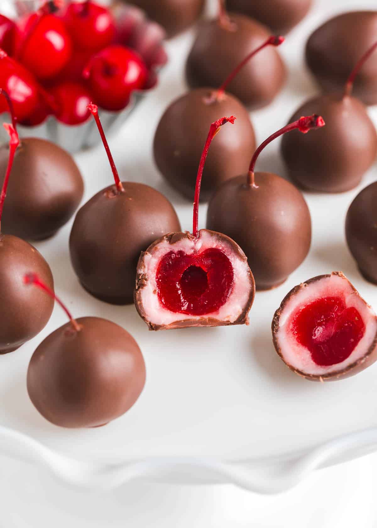 Chocolate covered cherry on a white plate.