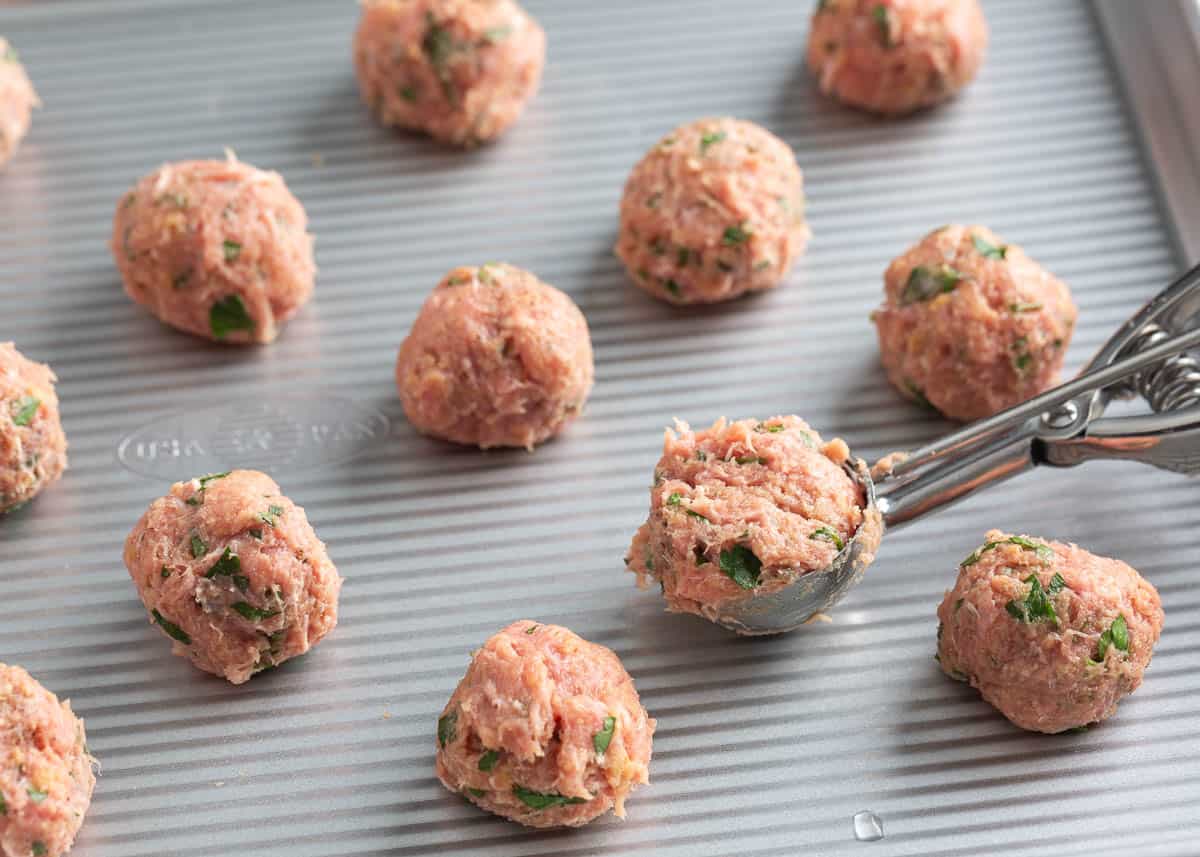 Showing how to make turkey meatballs.