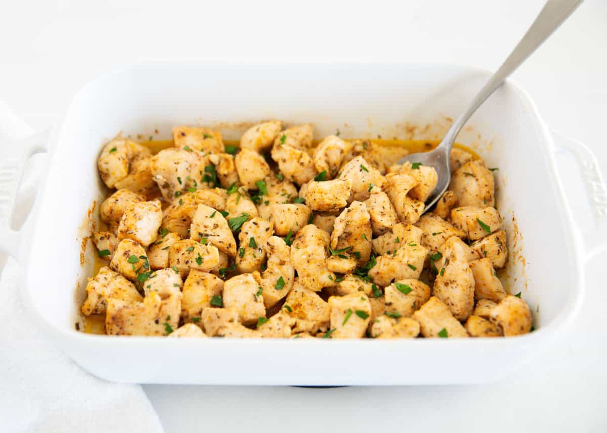 Cooked chicken bites in a baking dish.