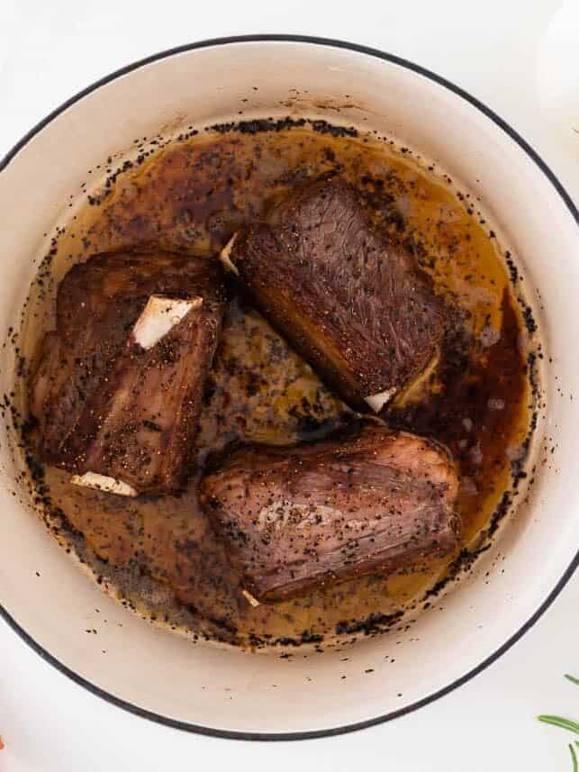 Beef short ribs in a Dutch oven.