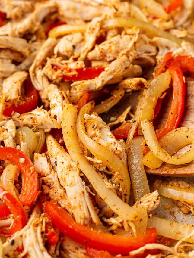 Onion, peppers and chicken in the skillet.