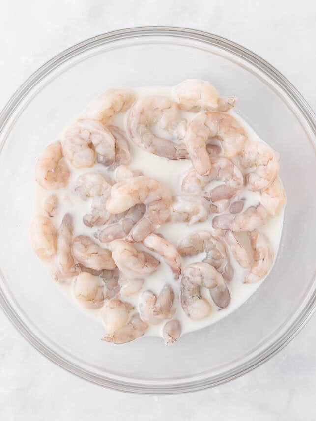 Shrimp marinating in buttermilk.