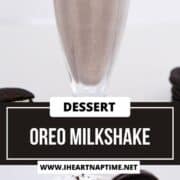 Oreo milkshake in a tall sundae glass.