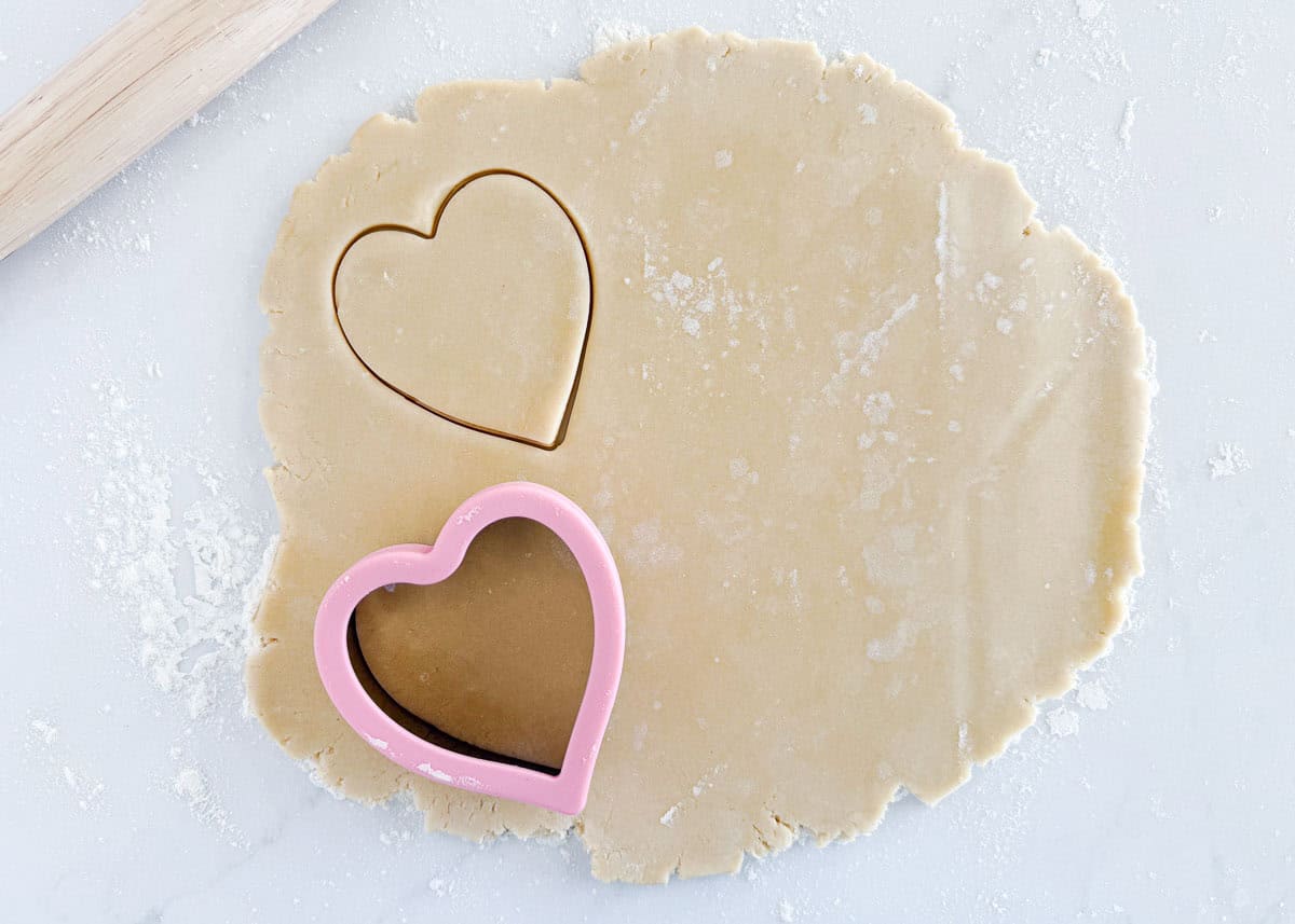 Cutting Valentine sugar cookies.